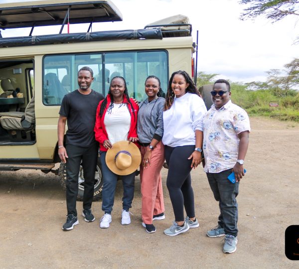 Simple Tours guests photographed with their safari Land Cruiser before a game drive